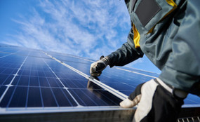 A man installing a solar panel
