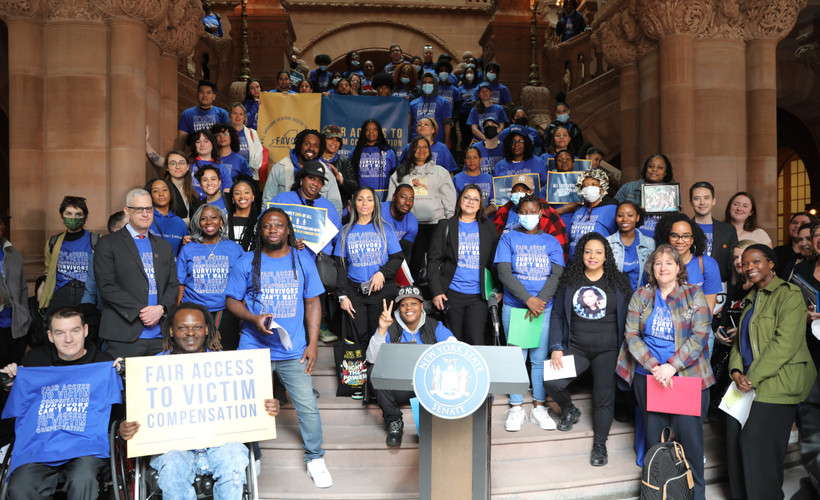 Advocates for survivors holding signs at a rally