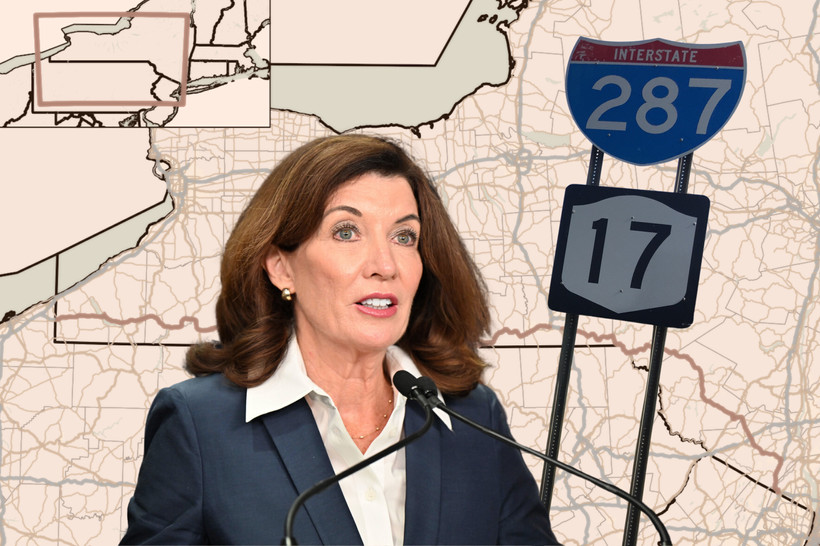 Kathy Hochul in front of a map of New York Route 17.