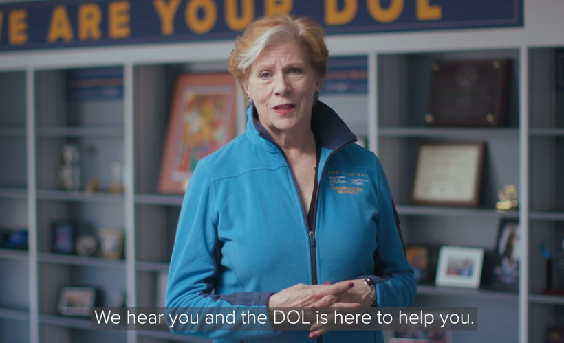 A video still of Labor Commissioner Roberta Reardon with a caption reading, "We hear you and the DOL is here to help you."