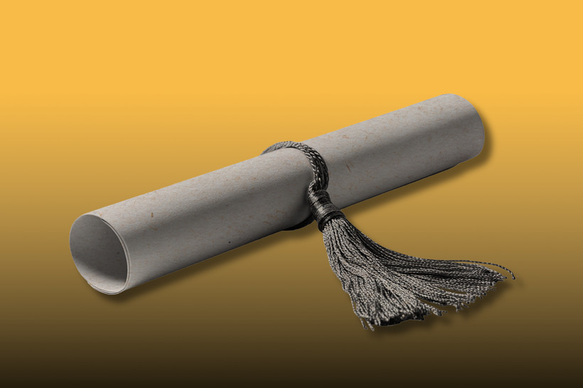 A high-contrast photo of a rolled up graduation diploma closed with a tassel against an orange and black background.