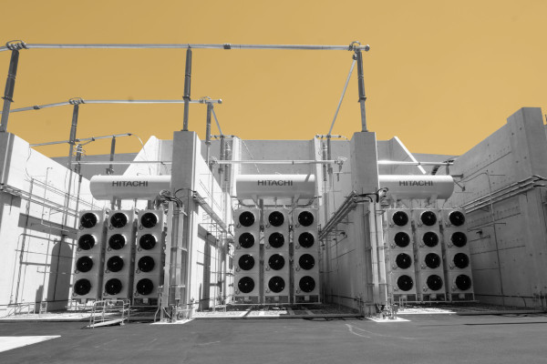 A photo of part of the Camplain Hudson Power Express Converter station, a towering white structure featuring three blocks of twelve fans each.
