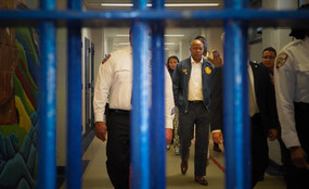 Eric Adams seen through bars at Rikers Island