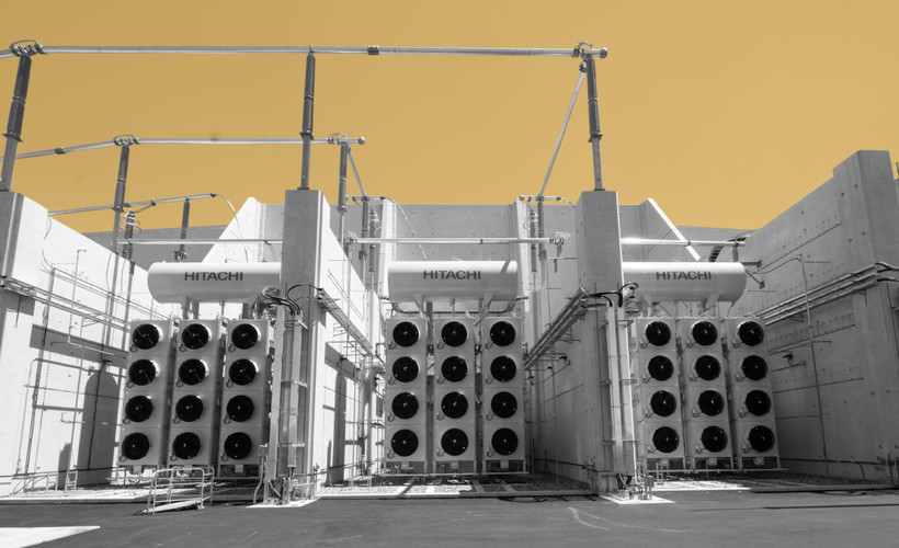 A photo of part of the Camplain Hudson Power Express Converter station, a towering white structure featuring three blocks of twelve fans each.