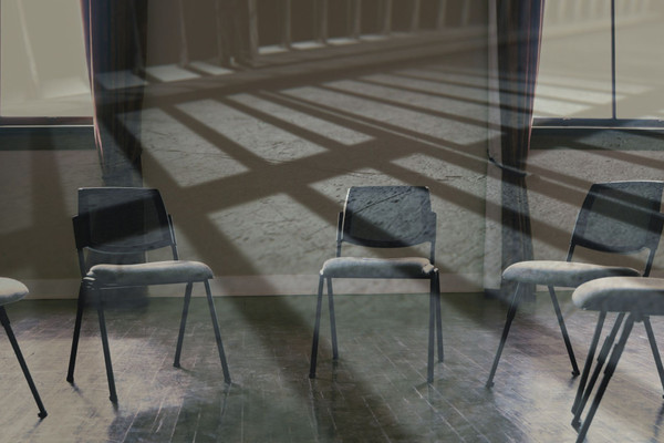 Empty chairs in a circle with the shadows of jail bars over it.