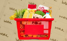A photo collage of a shopping basket full of groceries, in front of a yellow-tinted photo of a calendar with "work" written in many of the days.