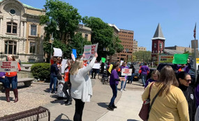 Photo of benefit workers' protest outside their office building in Syracuse