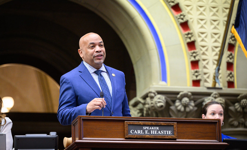 A photo of Assembly Speaker Carl Heastie walking towards the camera while looking off to the side.