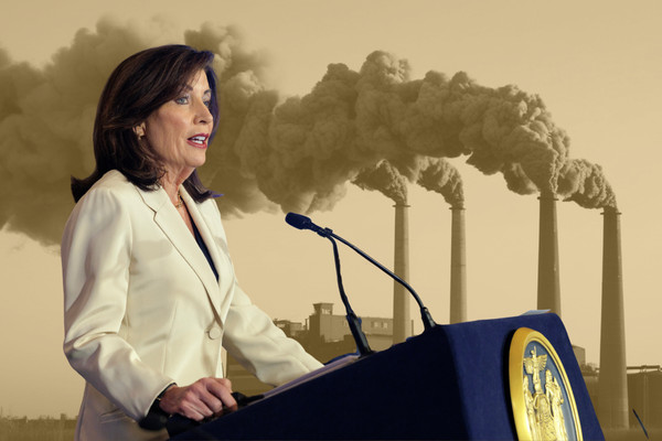 A photo collage of Governor Kathy Hochul in front of a yellow-tinted photo of four smokestacks.