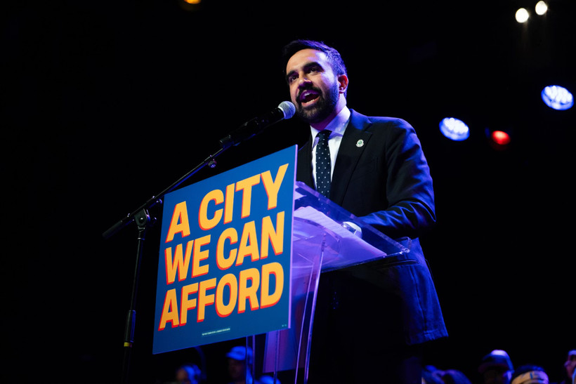 Zohran Mamdani speaking at a podium