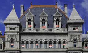 Albany State Capitol building with For Rent signs in the windows.