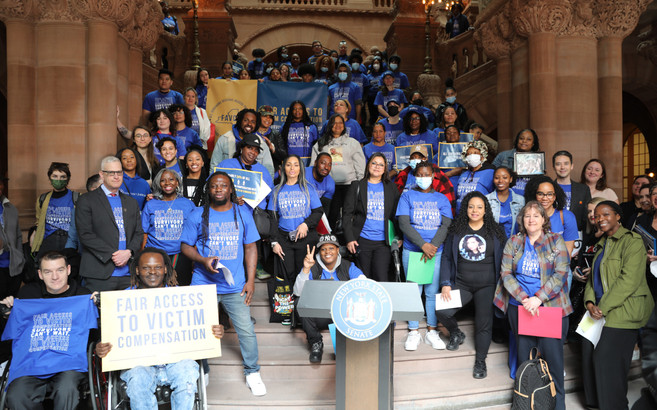 Advocates for survivors holding signs at a rally