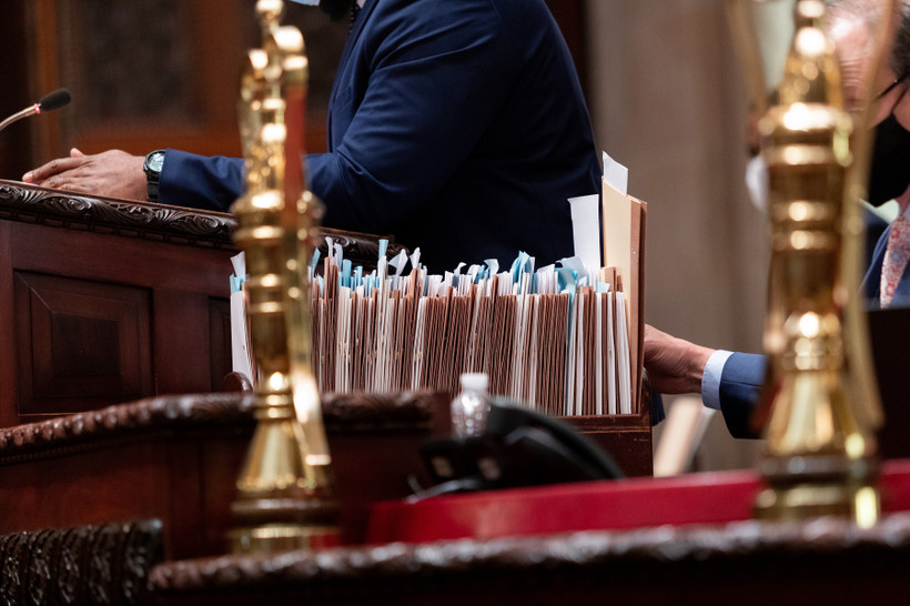 A bin of bills sits next to the Senate Journal Clerk on July 22, 2020.
