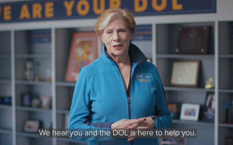 A video still of Labor Commissioner Roberta Reardon with a caption reading, "We hear you and the DOL is here to help you."