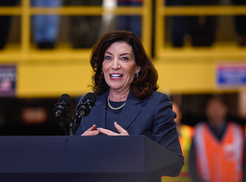 Governor Kathy Hochul speaks at a podium at the Long Island Rail Road West Side Yard in 2023.