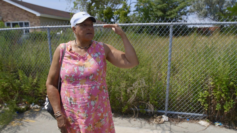 Longtime resident Sonja Webber-Bay shows how high the water reached on the streets of Edgemere during Superstorm Sandy in 2012. “The ocean and the bay were one in the same,” she says. “So whatever was in your house was the ocean and the bay.”