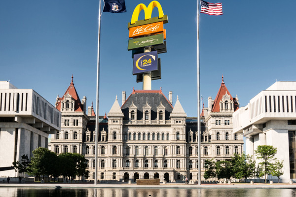 An illustration of a McDonalds sign above the New York State Capitol