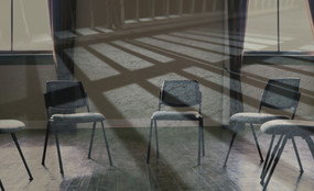 Empty chairs in a circle with the shadows of jail bars over it.