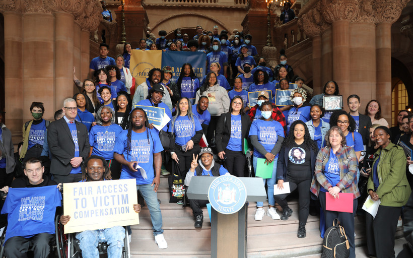 Advocates for survivors holding signs at a rally