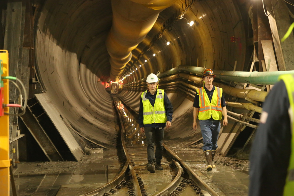 Deputy Commissioner for the Bureau of Water Supply Paul Rush and Sean McAndrew of the Bureau of Engineering Design and Construction in yellow work vests inside of the bypass tunnel for the Delaware Aqueduct.