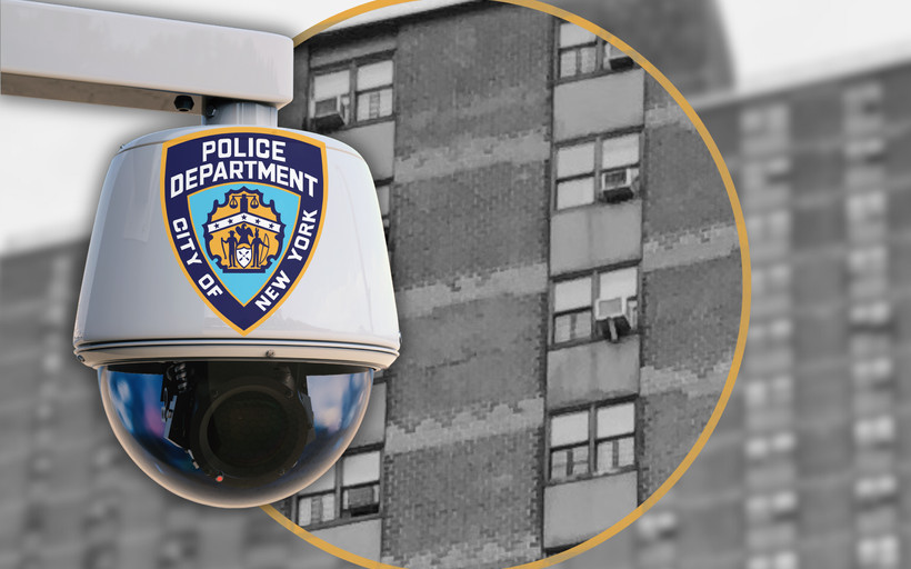 A NYPD camera set against a public housing building