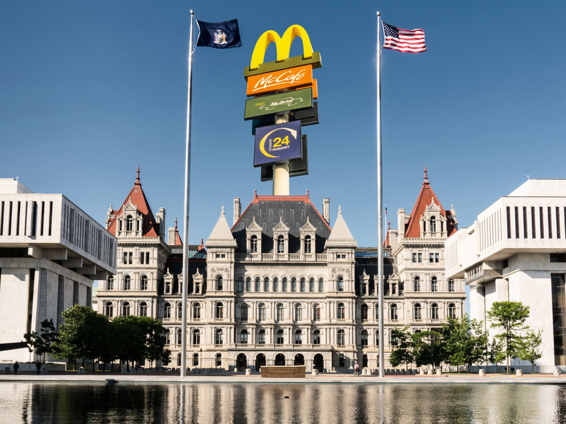 An illustration of a McDonalds sign above the New York State Capitol
