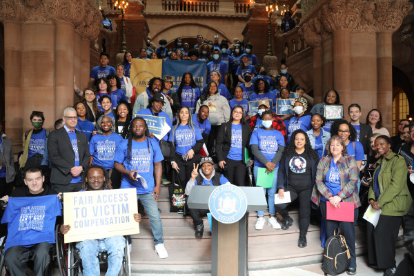 Advocates for survivors holding signs at a rally