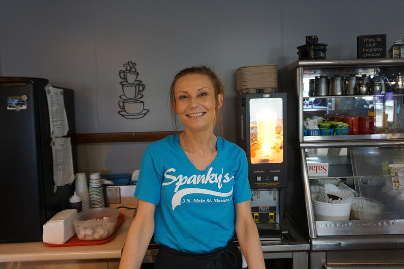 Brittany Horton stands before a counter wearing a Spanky's diner t-shirt.