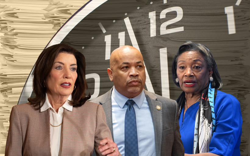 Photo collage of Governor Kathy Hochul, Assembly Speaker Carl Heastie, and Senate Majority Leader Andrea Stewart-Cousins. Behind them, a huge clock nears midnight, and stacks of papers loom.