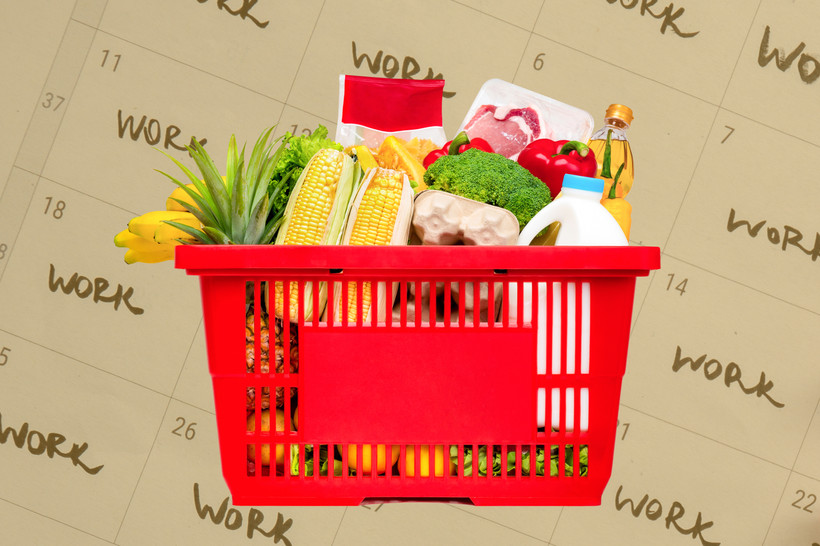 A photo collage of a shopping basket full of groceries, in front of a yellow-tinted photo of a calendar with "work" written in many of the days.