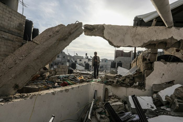 A Palestine stands amongst rubble in Gaza, following an Israeli attack on January 17.