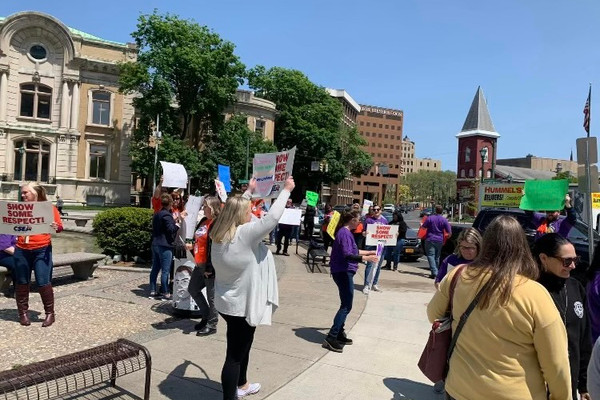 Photo of benefit workers' protest outside their office building in Syracuse