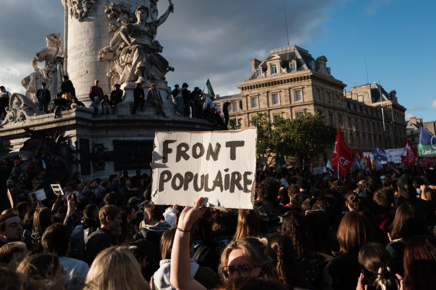 A protester holds a placard reading "Popular Front" during a Paris demonstration on June 10, 2024.