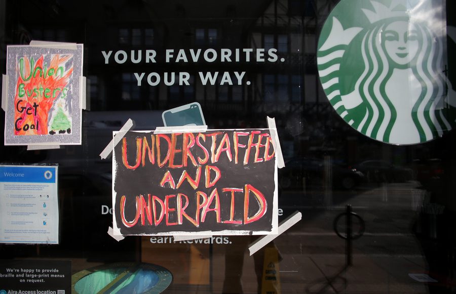 Workers taped signs to the windows of a closed Starbucks location on the chains annual Red Cup Day.