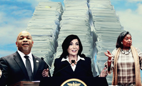 Assembly Speaker Carl Heastie, Governor Kathy Hochul, and Senate Majority Leader Andrea Stewart-Cousins before three tall stacks of paper.
