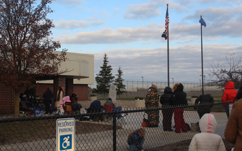 Visitors bundled up against the cold stand in line outdoors in the early morning before visiting starts at Five Points Correctional Facility, on Nov. 22, 2025.