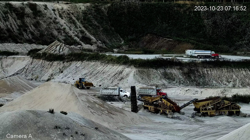 Trucks, bulldozers, and other equipment harvest sand on October 23.