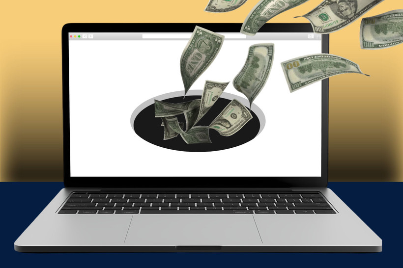 A website on an open laptop sucks in cash via a black hole.