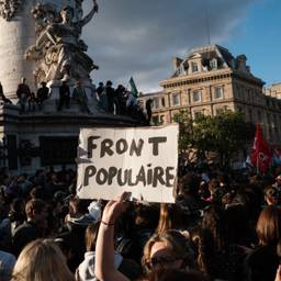 A protester holds a placard reading "Popular Front" during a Paris demonstration on June 10, 2024.