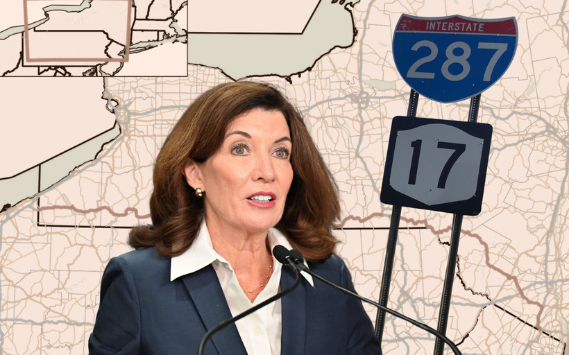 Kathy Hochul in front of a map of New York Route 17.