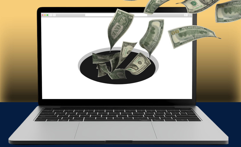 A website on an open laptop sucks in cash via a black hole.