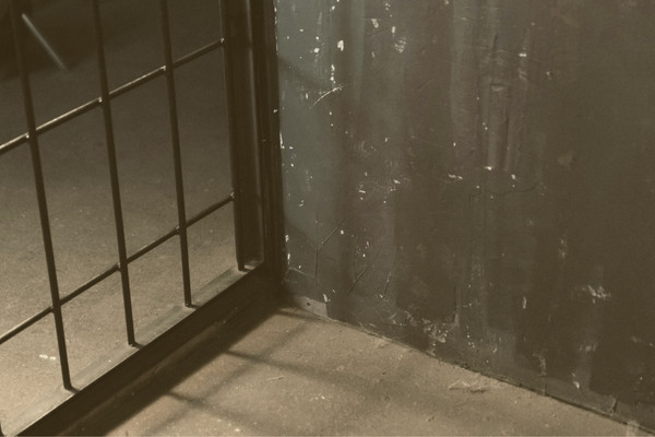 Close-up of the corner of a prison cell.
