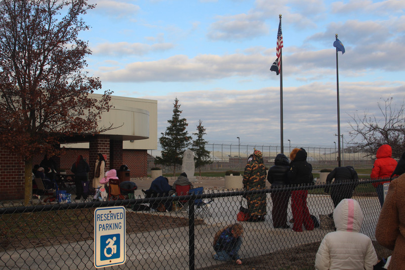 Visitors bundled up against the cold stand in line outdoors in the early morning before visiting starts at Five Points Correctional Facility, on Nov. 22, 2025.