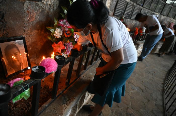People participate in a candle procession that culminates with an offering of light to the victims of El Mozote massacre.
