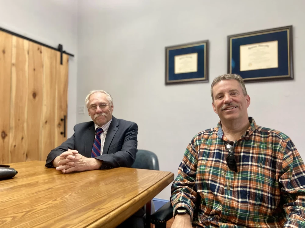 Attorney Ed Goehler and a Cortland County retiree at a table