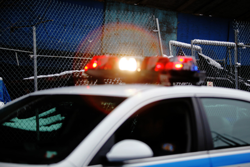 A cop car is flashing its lights.