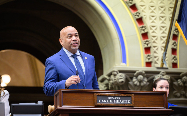A photo of Assembly Speaker Carl Heastie walking towards the camera while looking off to the side.